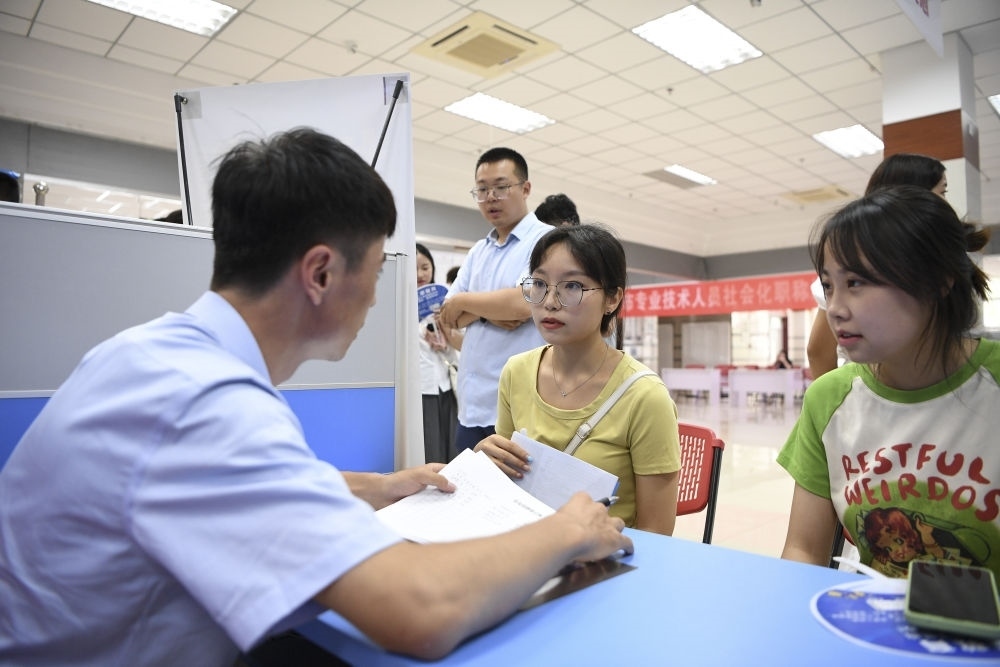 2023年7月29日，“揚(yáng)就業(yè)之帆，啟夢(mèng)想之旅”2023年寧夏（銀川）離校未就業(yè)高校畢業(yè)生招聘會(huì)在寧夏（銀川）人力資源服務(wù)產(chǎn)業(yè)園舉行。求職者（右）在招聘會(huì)現(xiàn)場(chǎng)與用人單位交流。新華社記者 馮開華 攝