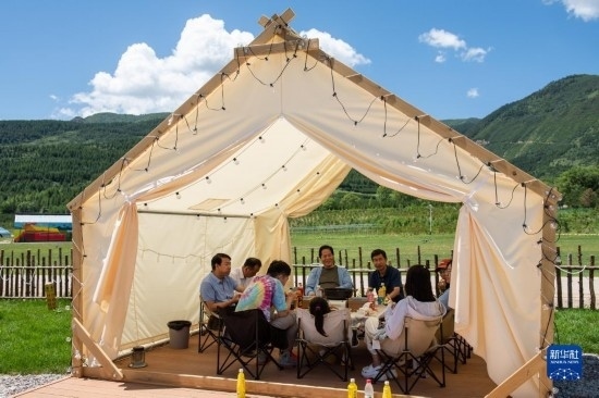 8月12日，游客在寧夏固原市涇源縣大灣鄉(xiāng)楊嶺村品嘗當地美食。新華社記者 李旭倫 攝