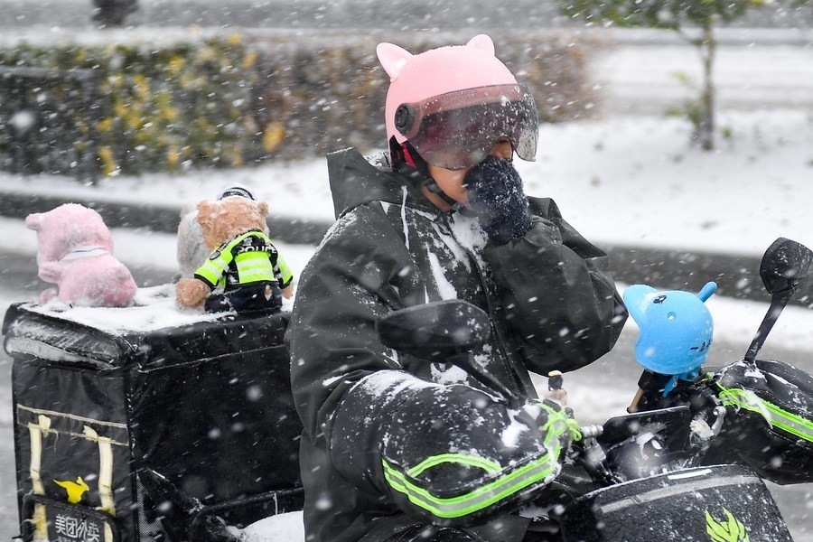 11月6日，在長春市街頭，一名外賣員在雪中騎行。新華社記者 許暢 攝