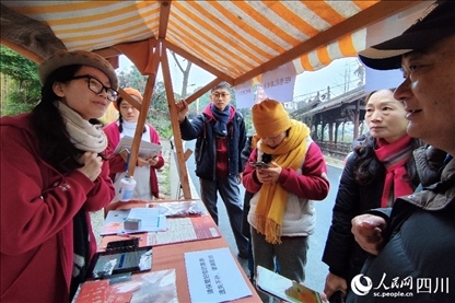 1月6日，“2024成都蒲江柑甜采摘節(jié)”上，記者見到了小萌（左一）和許多年輕人忙著做訪客接待、現(xiàn)場布置、票務(wù)核對、采摘服務(wù)等工作。人民網(wǎng)記者朱虹攝