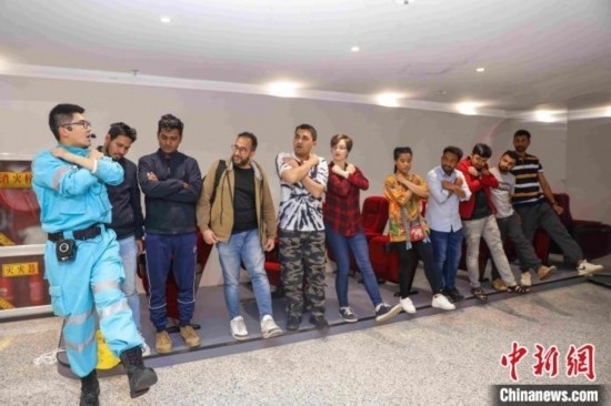 5月9日，工作人員指導(dǎo)留學(xué)生練習(xí)逃生技巧。張鷹 攝