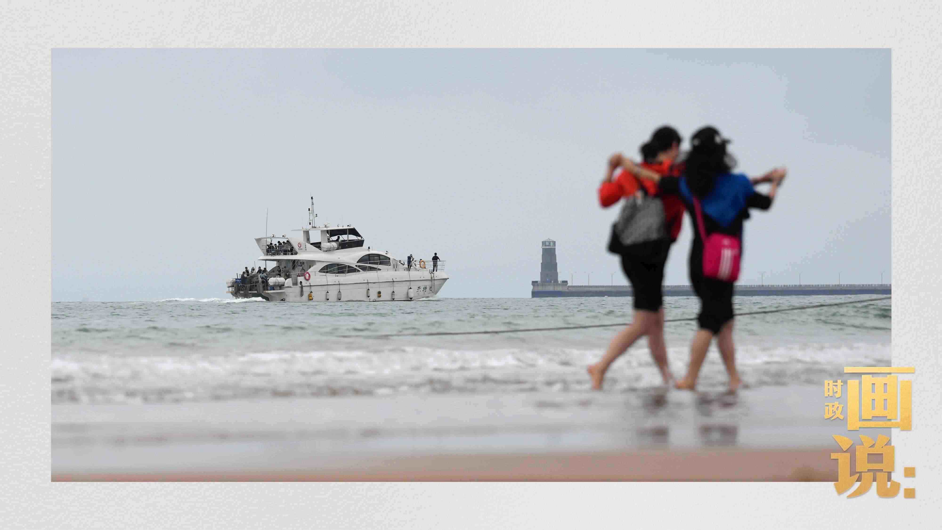 △日照陽光海岸綠道上的萬平口景區(qū)，一對游客在海浪中翩然起舞。