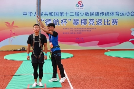 11月23日，工作人員為上海隊選手付樂樂（左）系安全繩。新華社記者 楊植森 攝